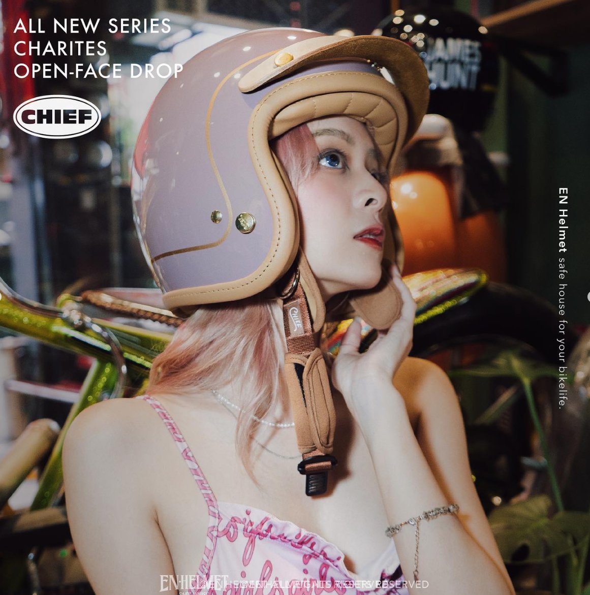 Campaign: model holding a teal open-face helmet against her shoulder